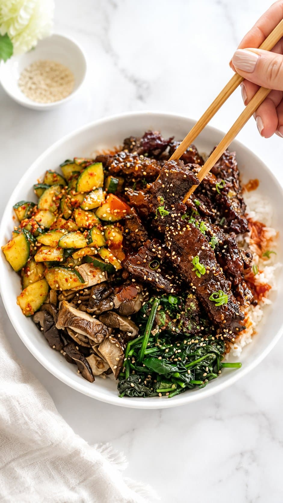 Bulgogi beef bowl with sesame spinach, mushrooms, and kimchi cucumbers